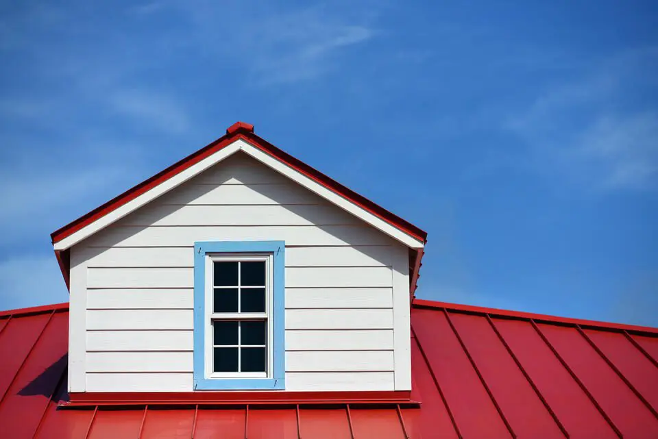 metal roof colors-red standing seam metal roof on a white house