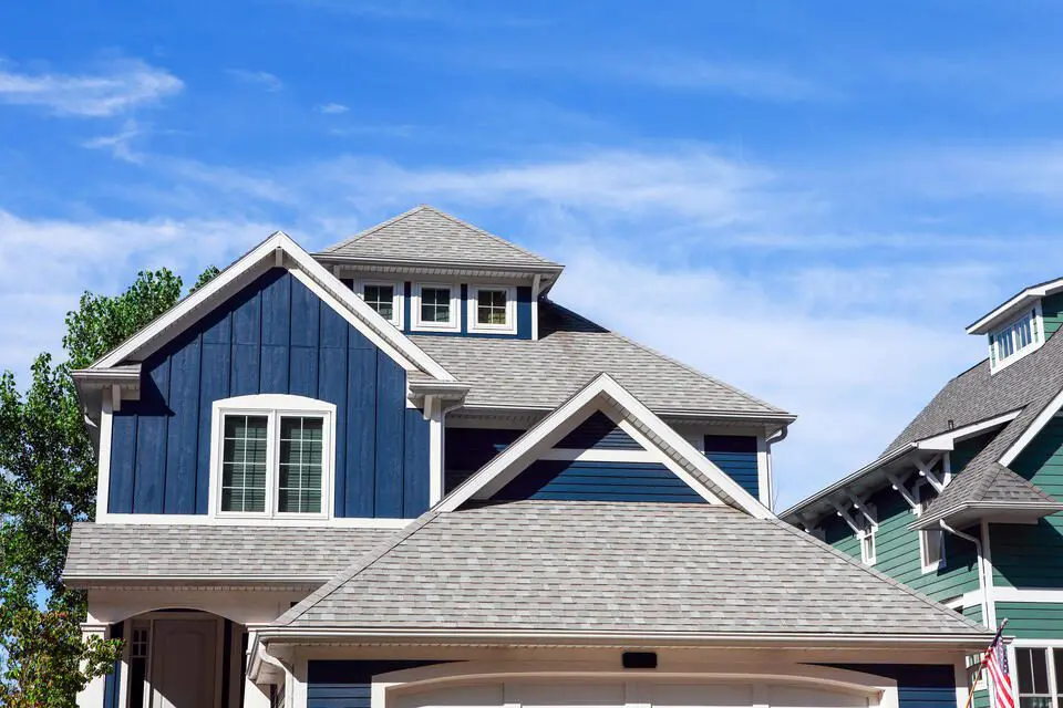 What Are The Best Roof Shingles For Your Home? (2025) - AllPhase Restoration best roof shingles-blue house with new light gray shingle roof