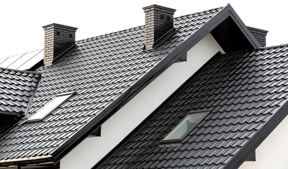 metal roof vs shingles-white house with black metal shingle roofing materials