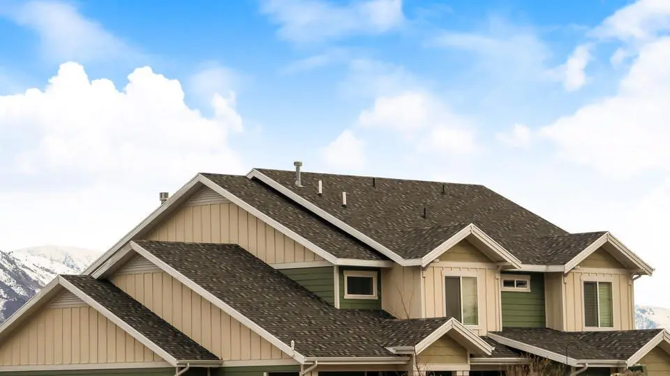 pitched roof-distant view of a house roof with dark shingles