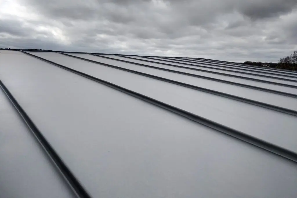 Close-up detail of house roof made from gray metal sheets.