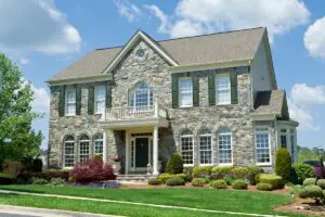 Well landscaped stone single family house. Home is a center hall colonial in suburban Maryland, United States.