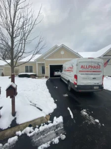Allphase restoration truck outside a home on a snowy day