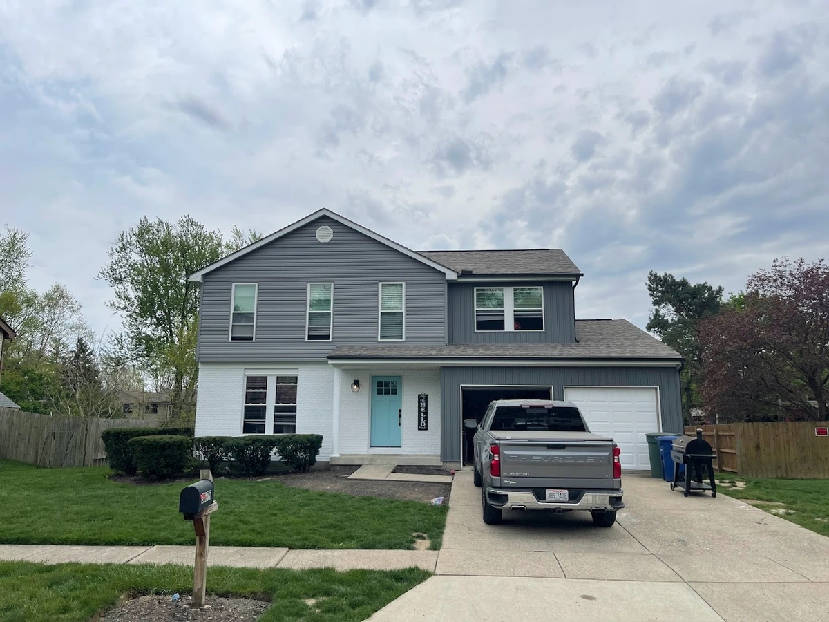 gray and white home receiving a new roof installation