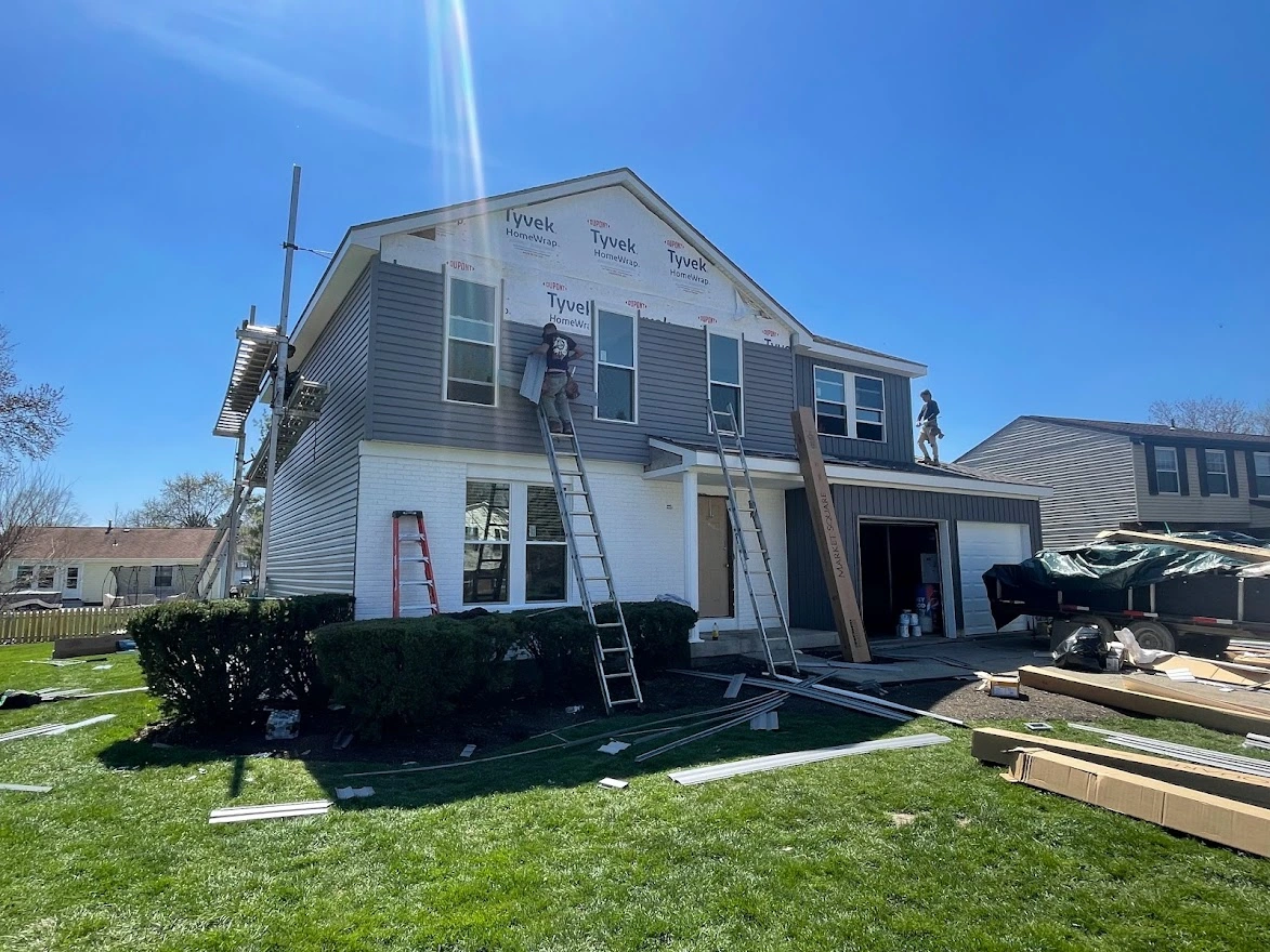 new gray siding installation on a suburban house
