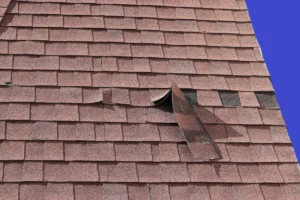 loose roofing shingles on house roof