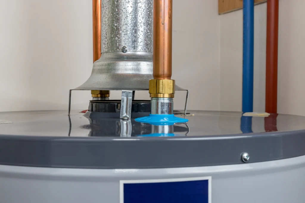 Why Is My Water Heater Leaking From Top? (6 Possible Reasons) - All Phase Roofing & Restoration Close up view of a water heater leaking from top of tank