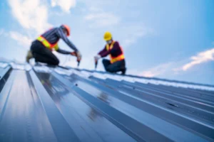 men working on a metal roof slope