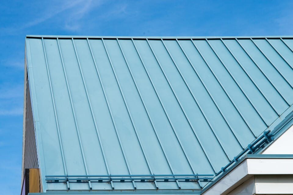 7 Most Popular Metal Roof Colors (2025) - All Phase Roofing & Restoration metal roof colors-blue standing seam metal roof