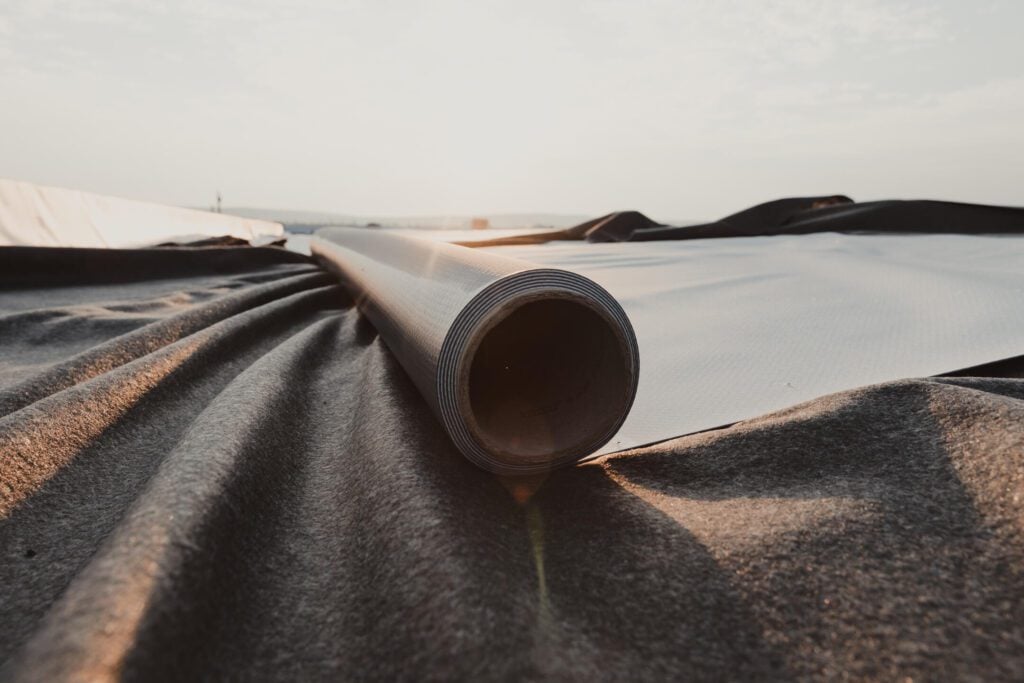 Homepage (Youtech) - All Phase Roofing & Restoration rubber roof repair-close up of rubber roofing materials on a flat roof ready for installation