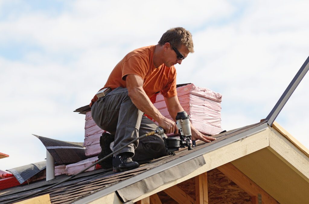 Parma Roofing - All Phase Roofing & Restoration Building contractor putting the asphalt roofing on a large residential home