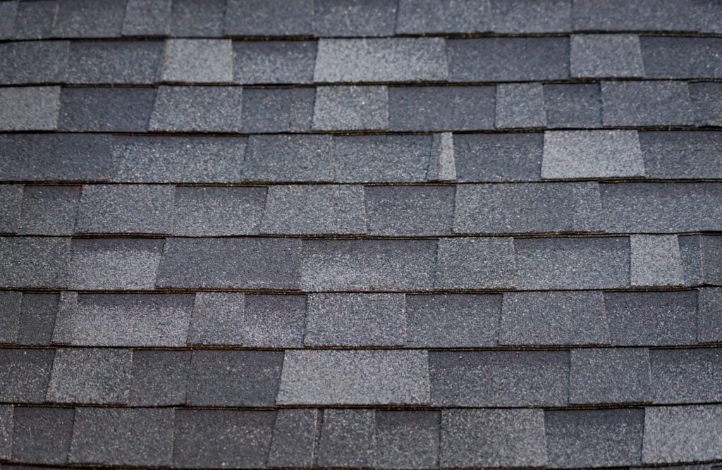 Architectural Shingles vs. 3-Tab: Pros & Cons - All Phase Roofing & Restoration A pattern created by asphalt shingles on a roof.