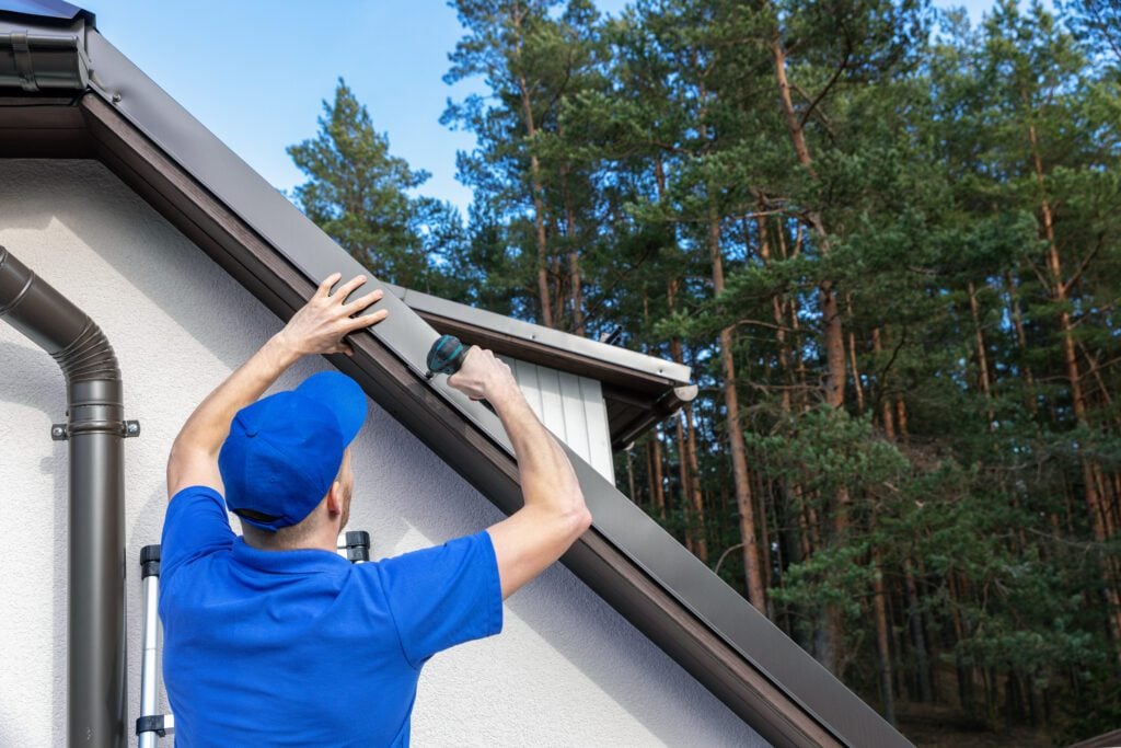 5 Best Roofing Companies in Akron Ohio - All Phase Roofing & Restoration roofer installing metal drip edge profile on the house roof