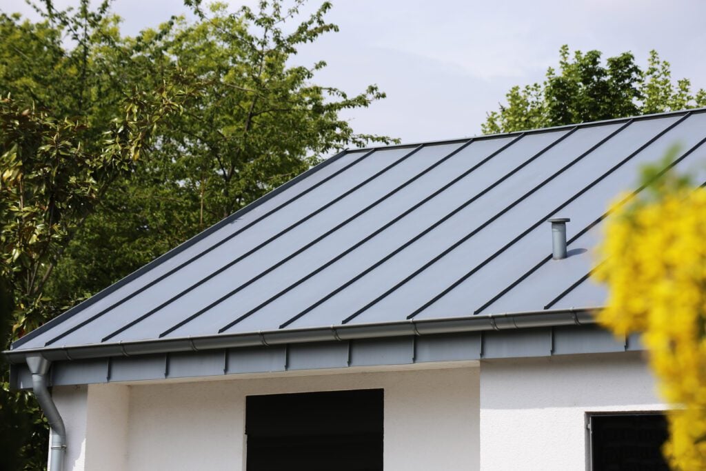 What Is A Standing Seam Metal Roof? & Key Benefits - All Phase Roofing & Restoration Metal standing seam roof on a residential home